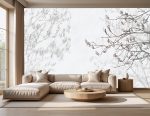 Jasna roślinna fototapeta z delikatnym cieniem gałązek, przedstawiona na dużej ścianie w salonie urządzonym w naturalnym stylu japandi.